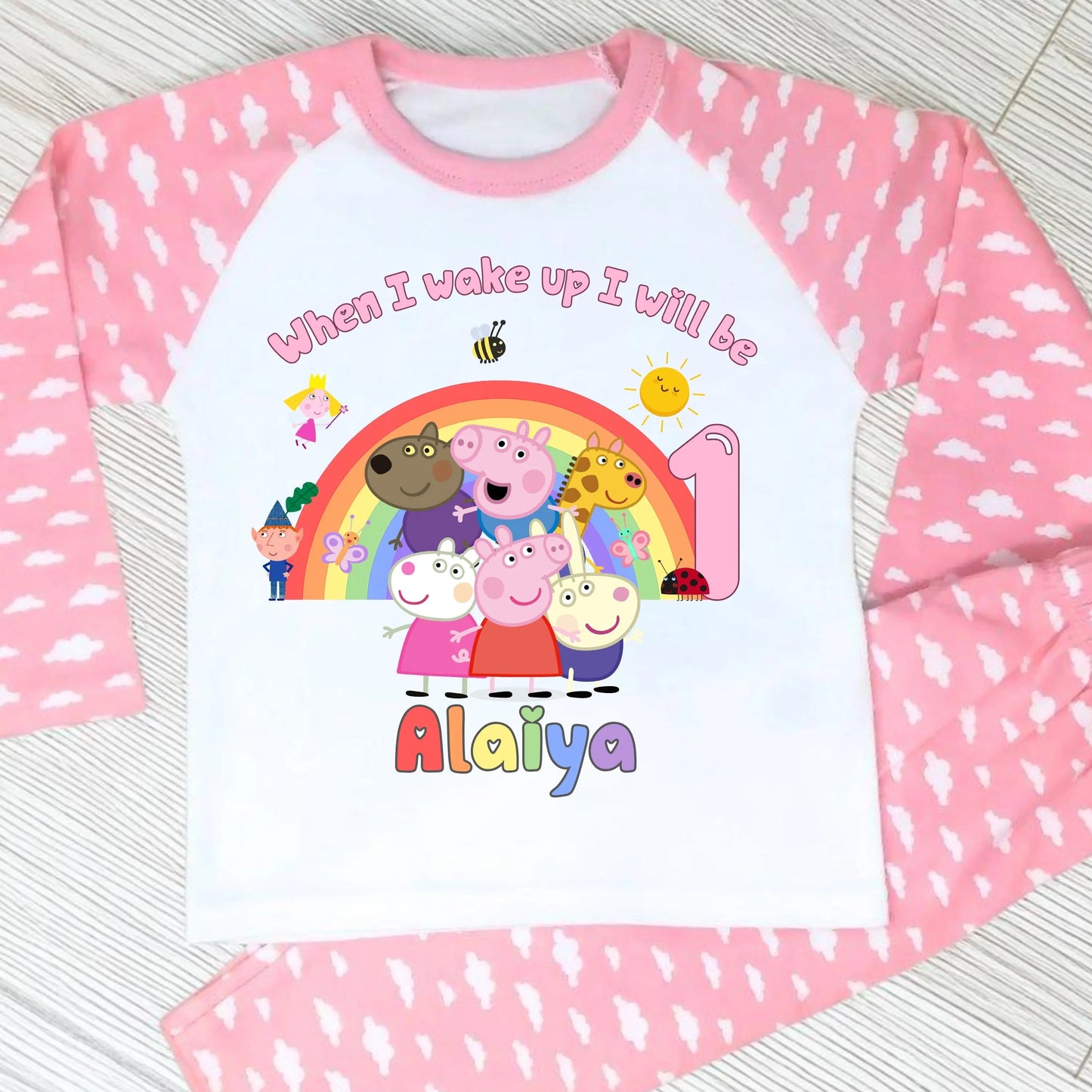 Pink Peppa Pig and friends personalised girls birthday pyjamas featuring a rainbow design and the text “When I wake up I will be with custom age and name, printed on a soft long-sleeve top and matching pink bottoms. Perfect personalised Peppa Pig birthday outfit for toddlers, ideal for first second third birthday celebrations, gifts, and bedtime photos.