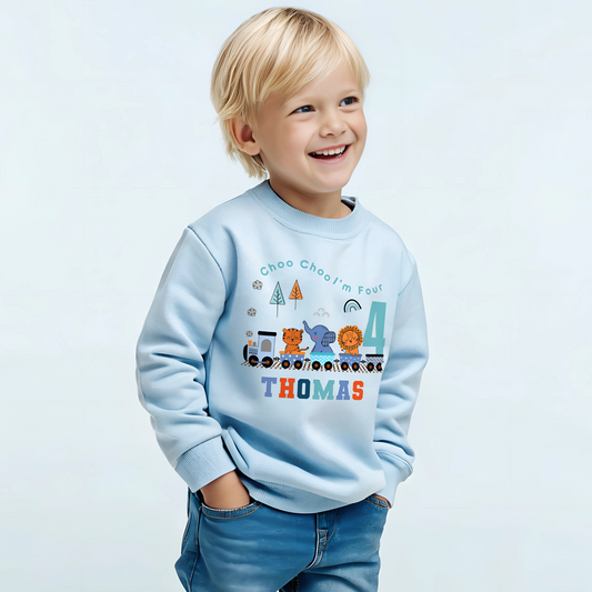 Safari birthday sweatshirt, White cotton t-shirt featuring a vibrant safari jungle theme designed for a boy's birthday party. The top is personalised with the phrase ‘Choo Choo I'm Two,’ or any age, and adorned with playful illustrations of jungle animals like lions, elephants, and giraffes, perfect for a safari-themed celebration. Also for boys that love trains. Boys toddler birthday shirt, personalised toddler gift ideas, jungle animal themed birthday party ideas.