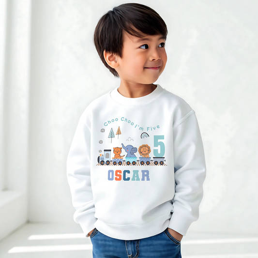 Safari birthday sweatshirt, White cotton t-shirt featuring a vibrant safari jungle theme designed for a boy's birthday party. The top is personalised with the phrase ‘Choo Choo I'm Two,’ or any age, and adorned with playful illustrations of jungle animals like lions, elephants, and giraffes, perfect for a safari-themed celebration. Also for boys that love trains. Boys toddler birthday shirt, personalised toddler gift ideas, jungle animal themed birthday party ideas.