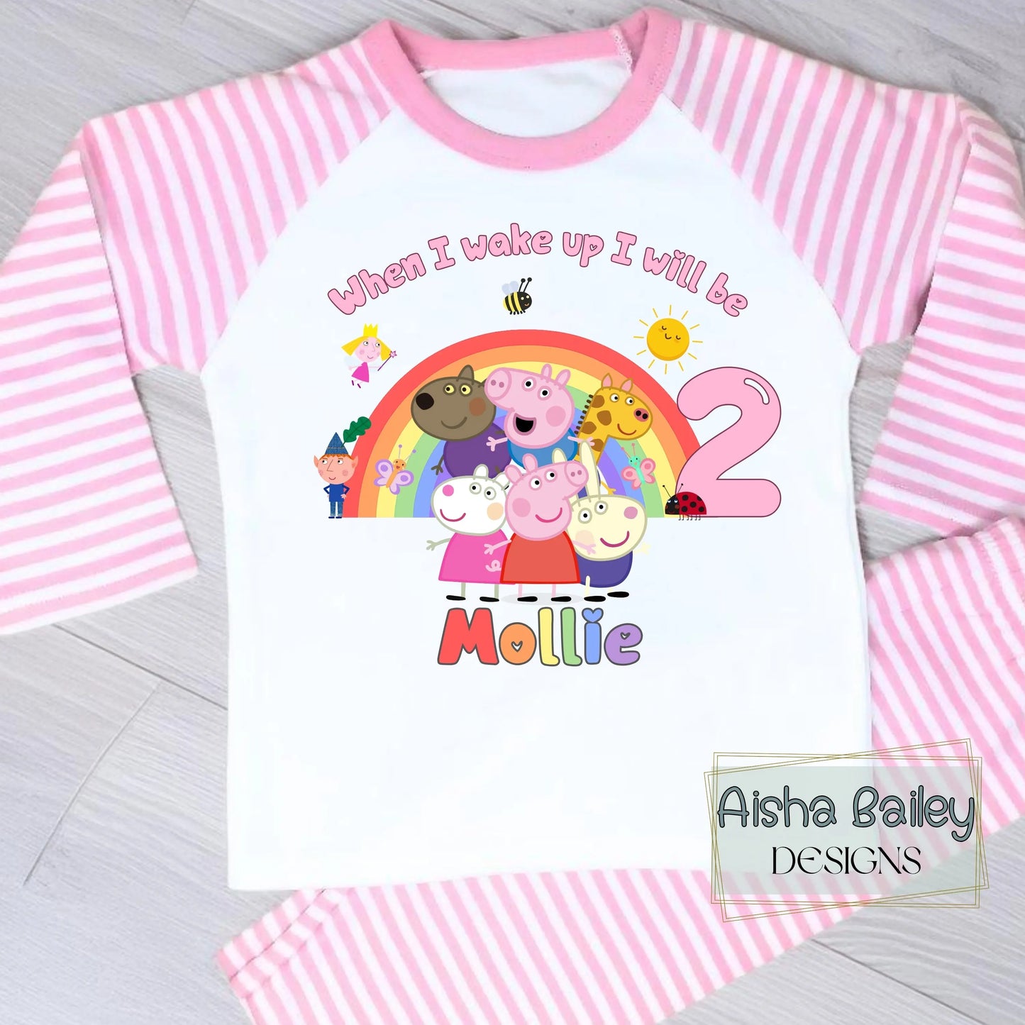 Pink Peppa Pig and friends personalised girls birthday pyjamas featuring a rainbow design and the text “When I wake up I will be with custom age and name, printed on a soft long-sleeve top and matching pink bottoms. Perfect personalised Peppa Pig birthday outfit for toddlers, ideal for first second third birthday celebrations, gifts, and bedtime photos.