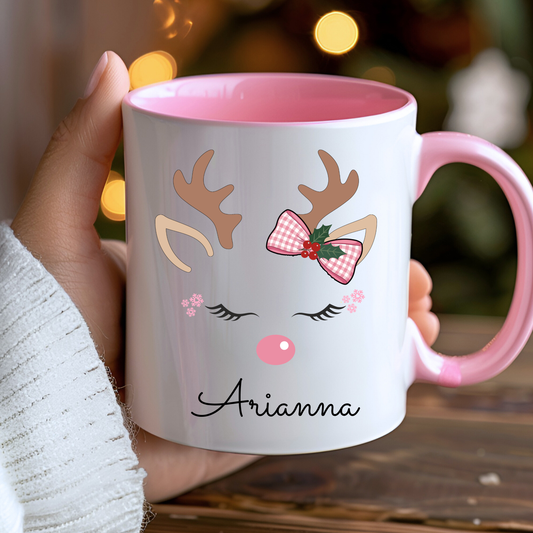 Personalised reindeer Christmas mug for girls featuring a pink bow and child’s name, available in polymer, ceramic and campervan styles.