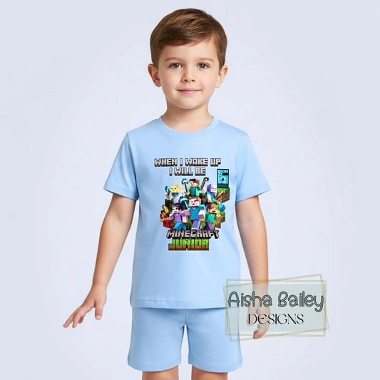 Minecraft Birthday Pyjama Shorts, Boy wearing personalised Minecraft birthday pyjamas with custom age on white t-shirt and matching shorts in a bright modern bedroom setting