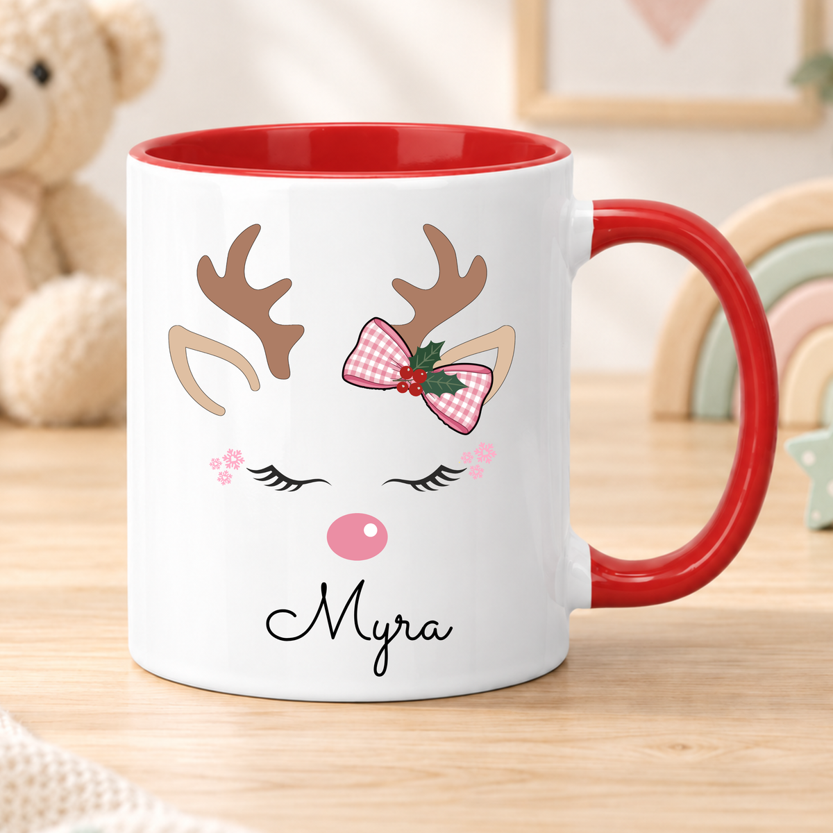 Personalised reindeer Christmas mug for girls featuring a pink bow and child’s name, available in polymer, ceramic and campervan styles.