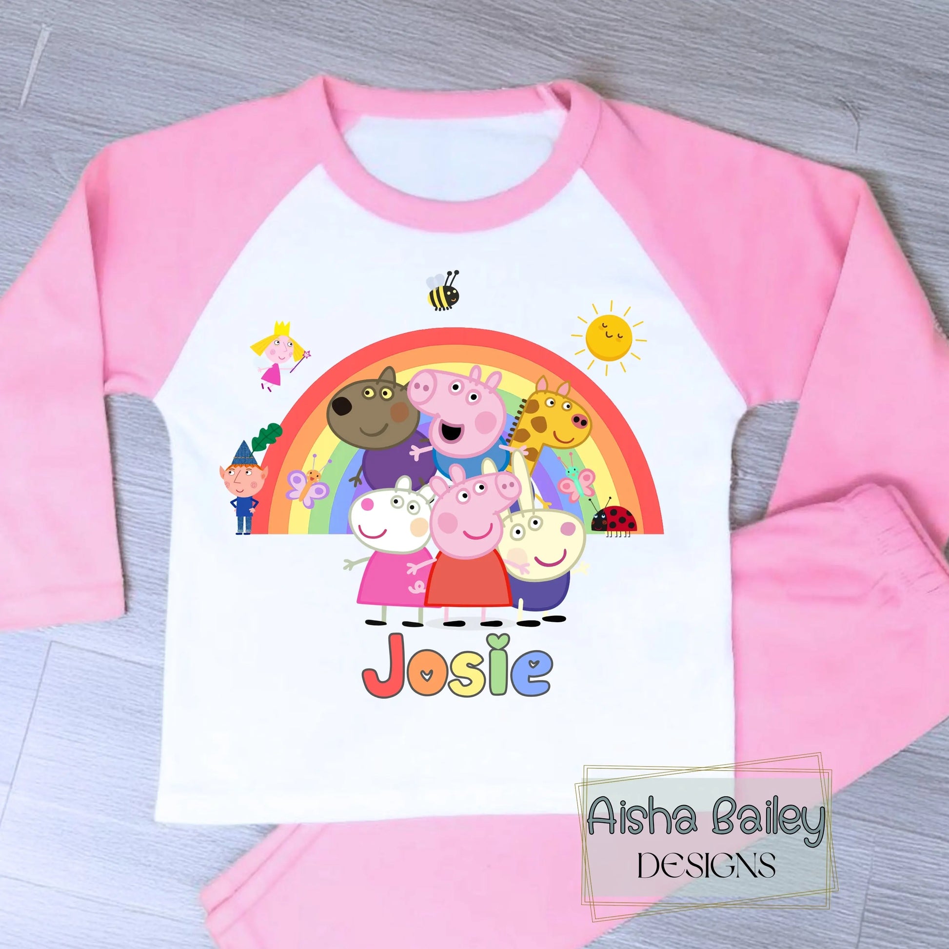 Pink Peppa Pig personalised girls pyjamas set featuring a colourful rainbow design and favourite Peppa Pig characters, customised with name and age. Made from soft, comfortable fabric with a long-sleeve top and matching cloud-print bottoms. Perfect for everyday wear, cosy nights, and relaxed mornings—ideal personalised Peppa Pig sleepwear for toddlers and young children.