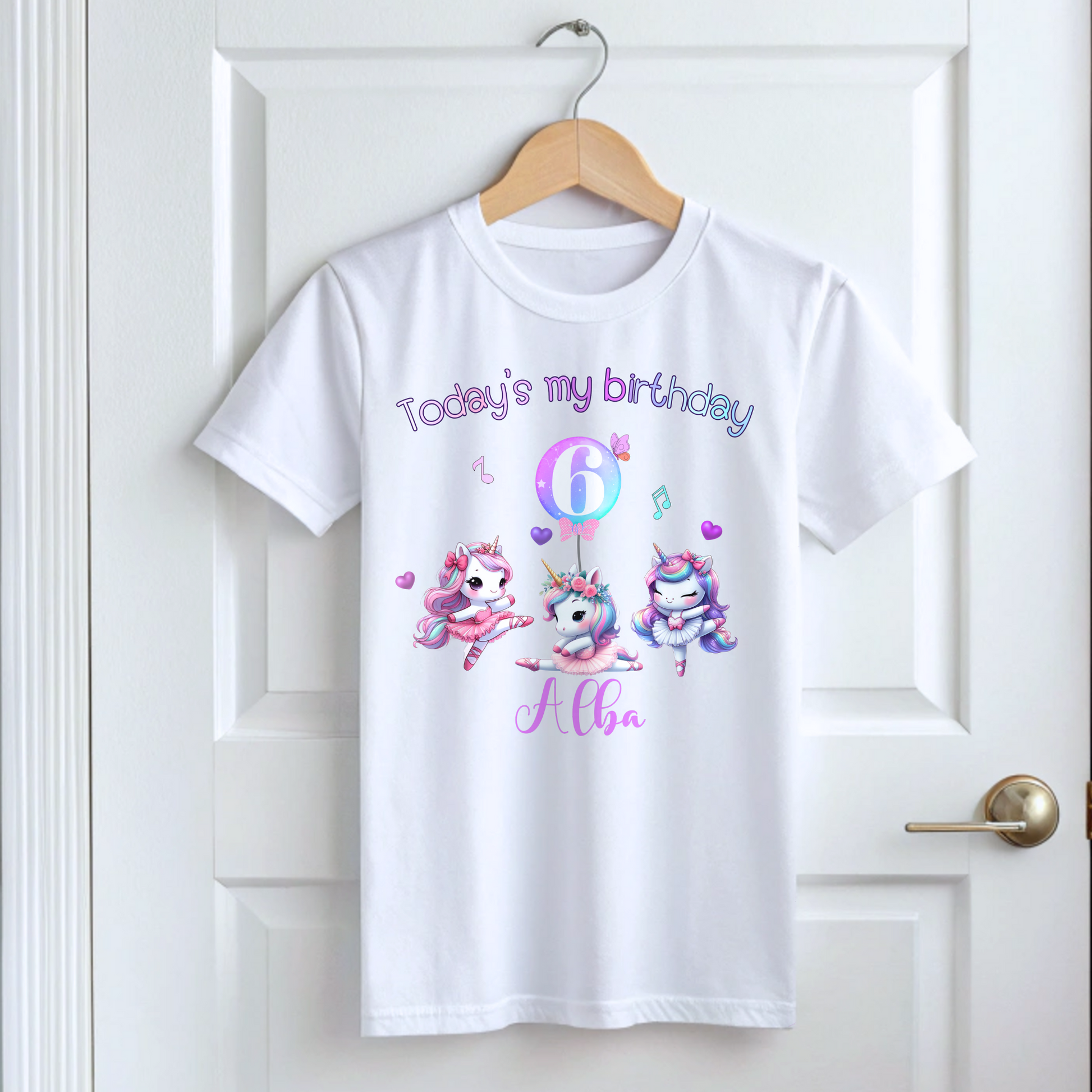 A pastel pink and lilac unicorn birthday T-shirt for girls and toddlers, featuring a cute unicorn design. Made from soft, breathable 100% cotton, this shirt offers both style and comfort. It can be personalised with a name, making it a unique birthday gift for girls. Perfect for a little dancer's birthday celebration, combining magic and comfort as she twirls and plays. Unicorn birthday gift, personalised unicorn, custom name tshirt