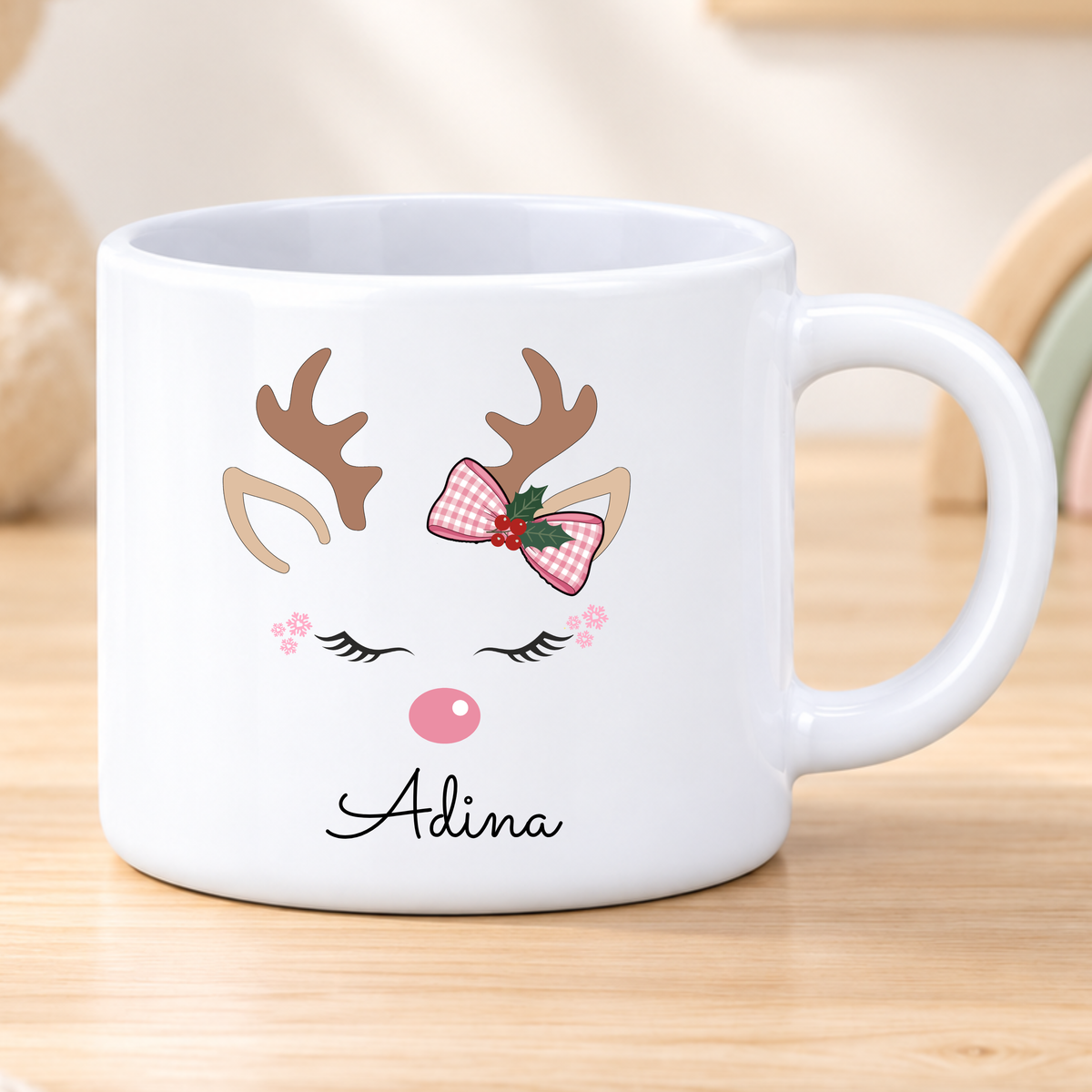 Personalised reindeer Christmas mug for girls featuring a pink bow and child’s name, available in polymer, ceramic and campervan styles.