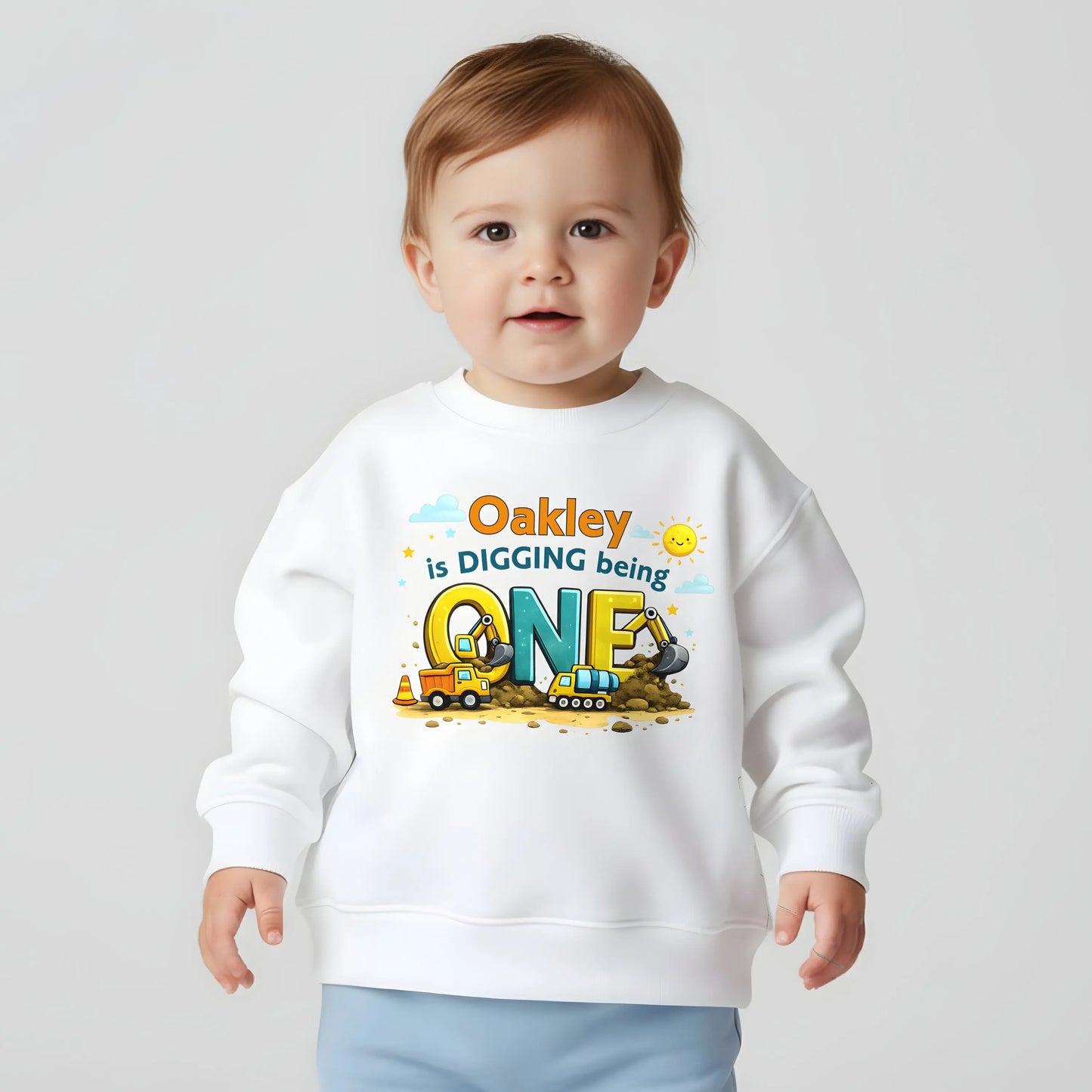 Digger birthdaysweatshirt personalised with child’s name and age, featuring colourful construction vehicles on a kids birthday jumper