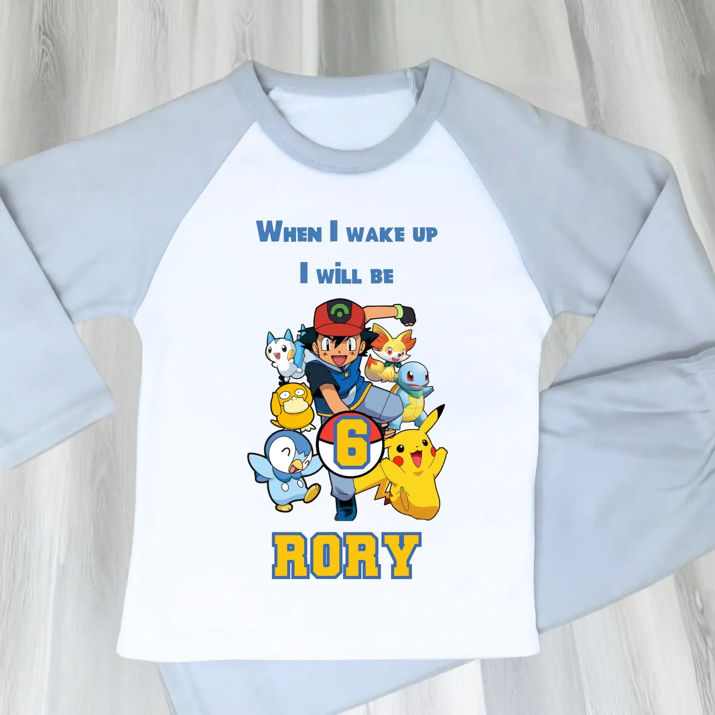 Pokomon birthday pyjamas: Children's PJst with Pokomon characters and text on a light blue and white background
