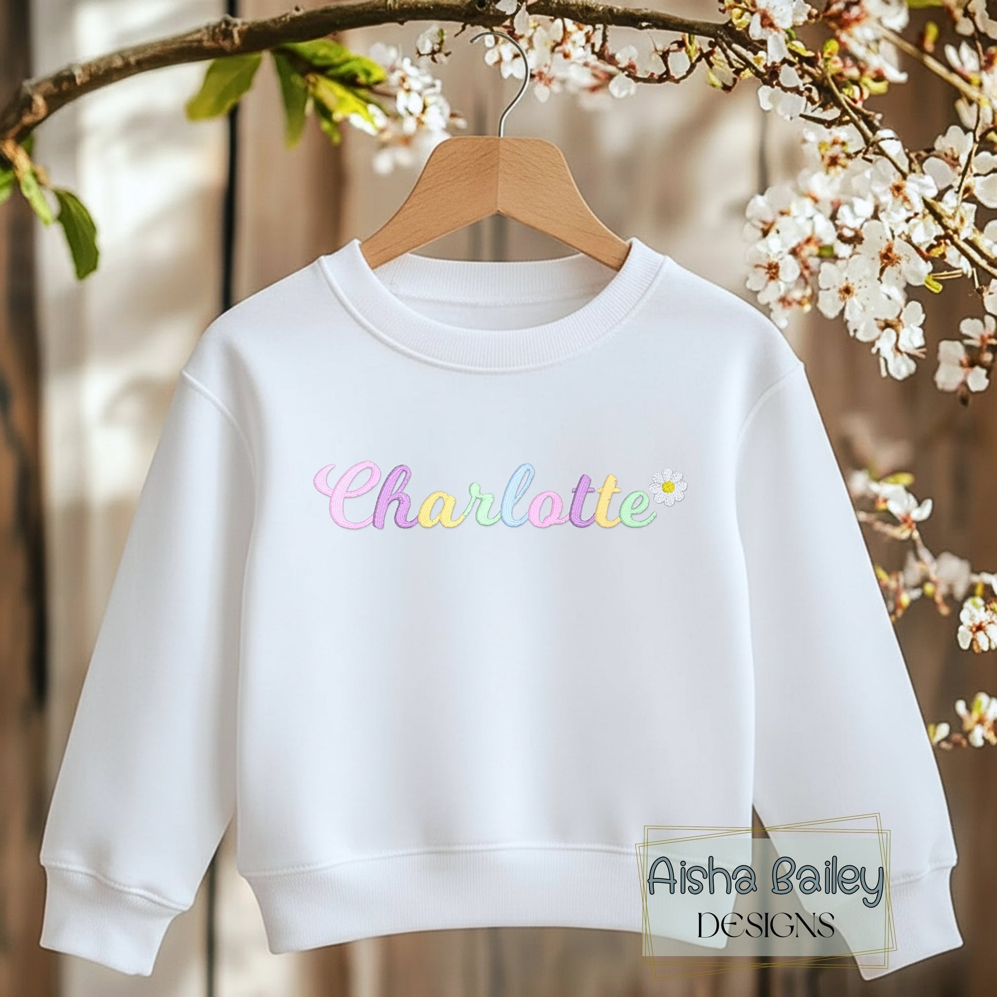 Girls personalised embroidered sweatshirt with custom name and pastal colours and daisy