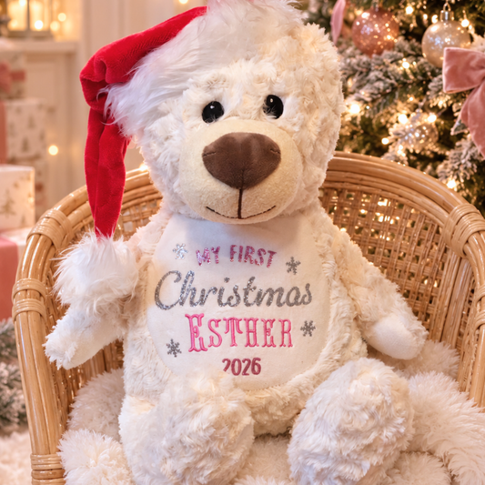 Personalised First Christmas Teddy Bear for baby with embroidered name, sparkling glitter vinyl Christmas design, soft cream fur and festive red Santa hat.