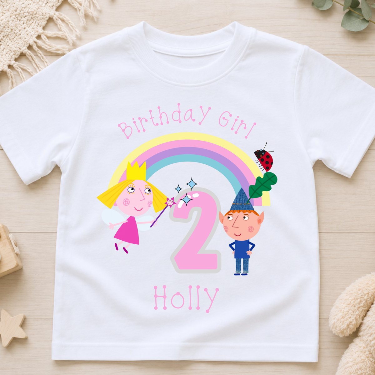 Personalised Ben and Holly Birthday T-Shirt for girls with name, age, rainbow, fairy and elf birthday design, available in pink, white and black.