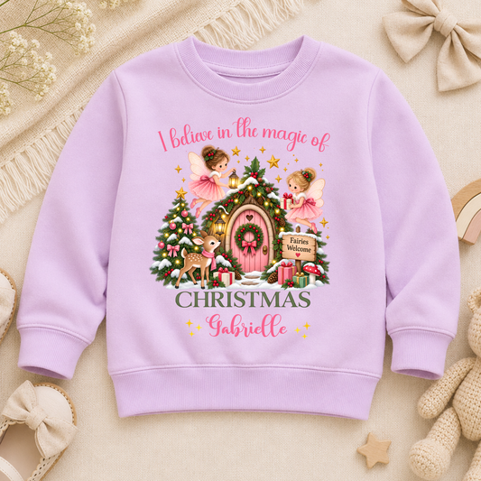 Personalised Christmas Sweatshirt for girls with magical fairies, pink fairy door, Christmas tree, woodland deer and child’s custom name.