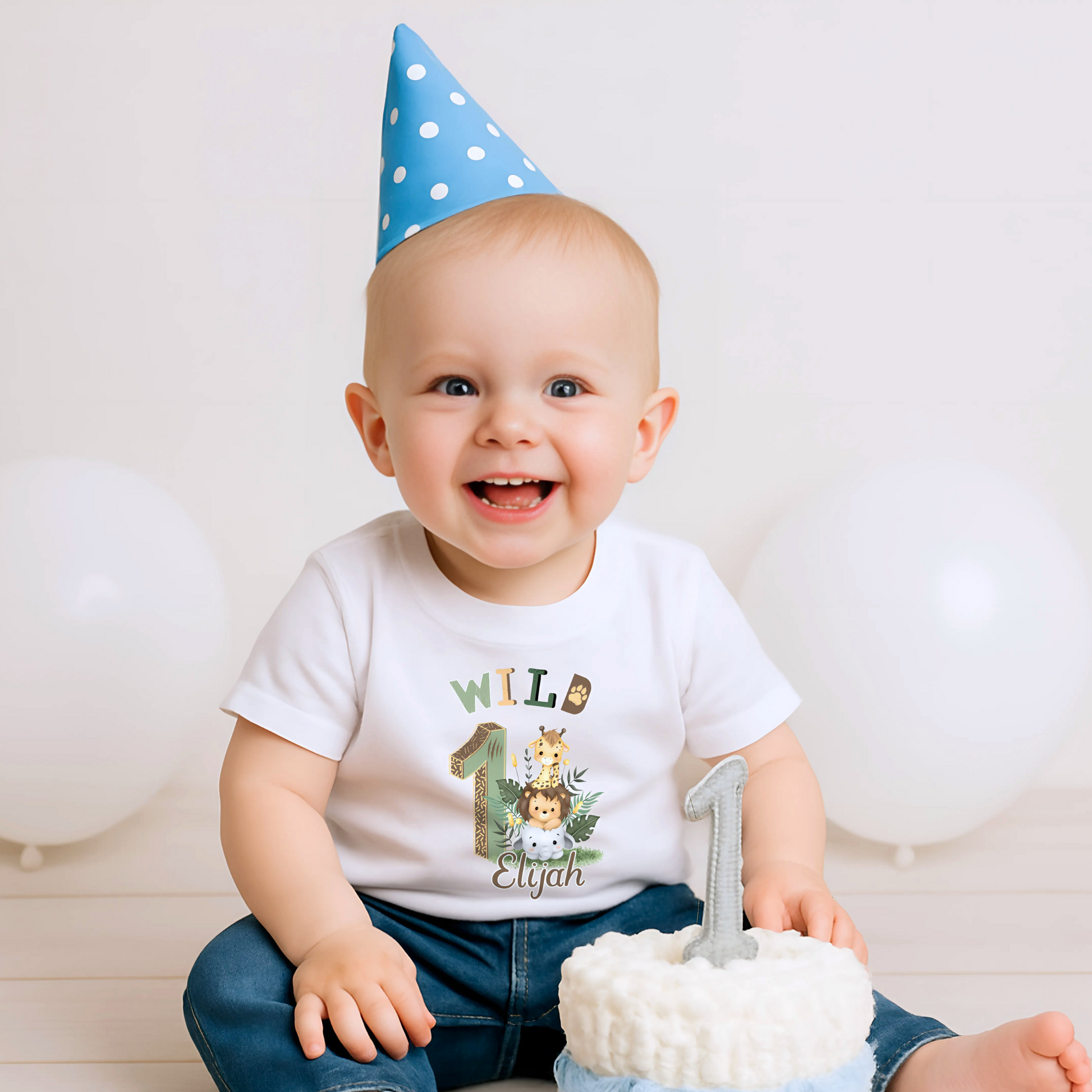 Wild One birthday t-shirt: A personalised Wild One 1st Birthday T-shirt for boys, featuring charming safari animals and vibrant colours. The shirt, designed for a jungle safari theme birthdays, includes space to customise with your child's name. Made from soft, high-quality materials, it promises comfort and style for your baby's first birthday celebration.