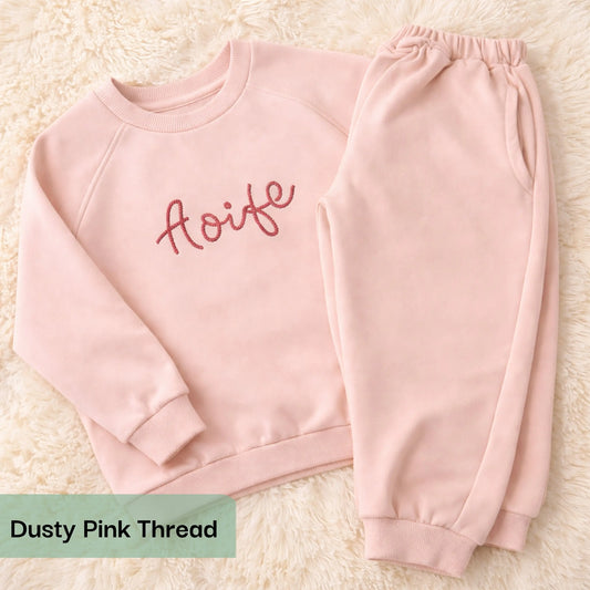 Personalised embroidered loungewear with a name: A child wearing a loungewear set with their name displayed on the front. Perfect for Christmas and birthday gifting