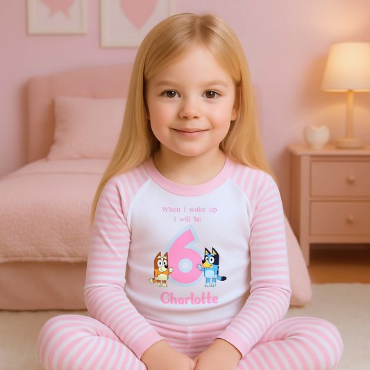 Bluey Birthday Pyjamas - Personalised Bluey and Bingo birthday pyjamas featuring vibrant prints of the beloved characters and a number to indicate the child's age. These delightful pyjamas, complete with the child's name, make bedtime an exciting continuation of the birthday festivities. Perfect for creating cherished birthday traditions and adding joy to the special day. Bluey pyjamas, Bingo pyjamas, birthday pyjamas, personalised children's pyjamas, birthday celebration, bedtime fun, toddler birthday