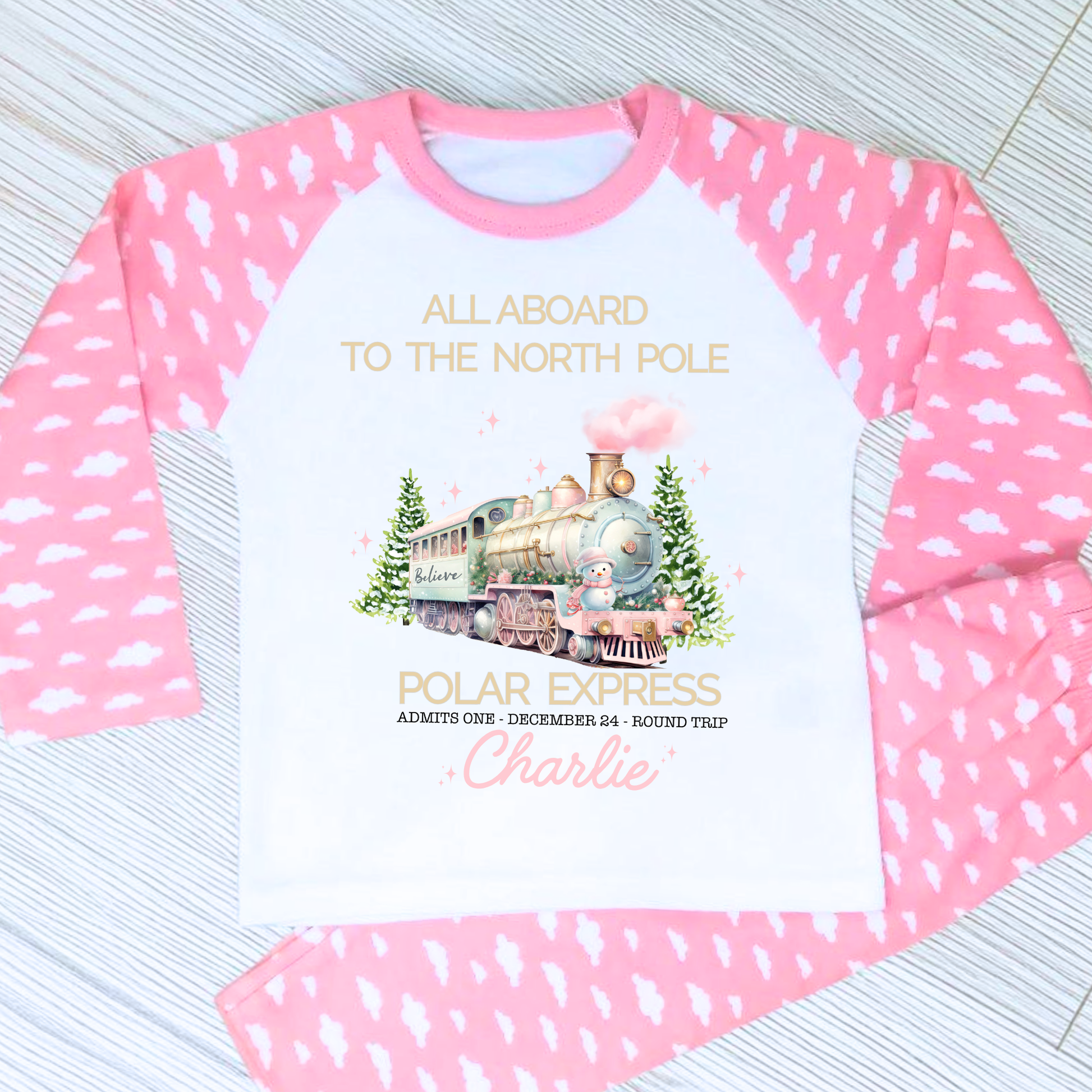 Polar express christmas pyjamas: A set of pink polar express Christmas Eve pyjamas for girls, personalised with a name. These pyjamas are designed to evoke the magic and wonder of the holiday season, made from soft, breathable fabric for a cozy night's sleep. Perfect for dreaming of a Polar Express journey to the North Pole. Girls polar express christmas pjs, christmas pyjamas personalised