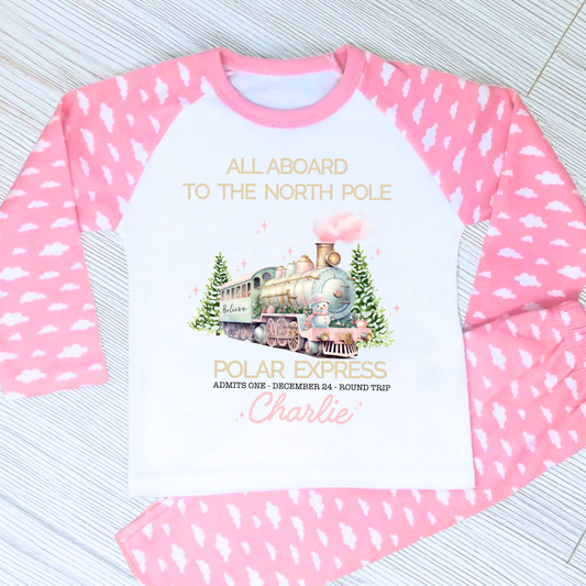 Polar express christmas pyjamas: A set of pink polar express Christmas Eve pyjamas for girls, personalised with a name. These pyjamas are designed to evoke the magic and wonder of the holiday season, made from soft, breathable fabric for a cozy night's sleep. Perfect for dreaming of a Polar Express journey to the North Pole. Girls polar express christmas pjs, christmas pyjamas personalised