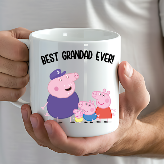 Personalised grandad mug: White ceramic personalised grandad mug with orange handle, Peppa Pig family illustration, and “Best Grandad Ever” text, with custom message on back.