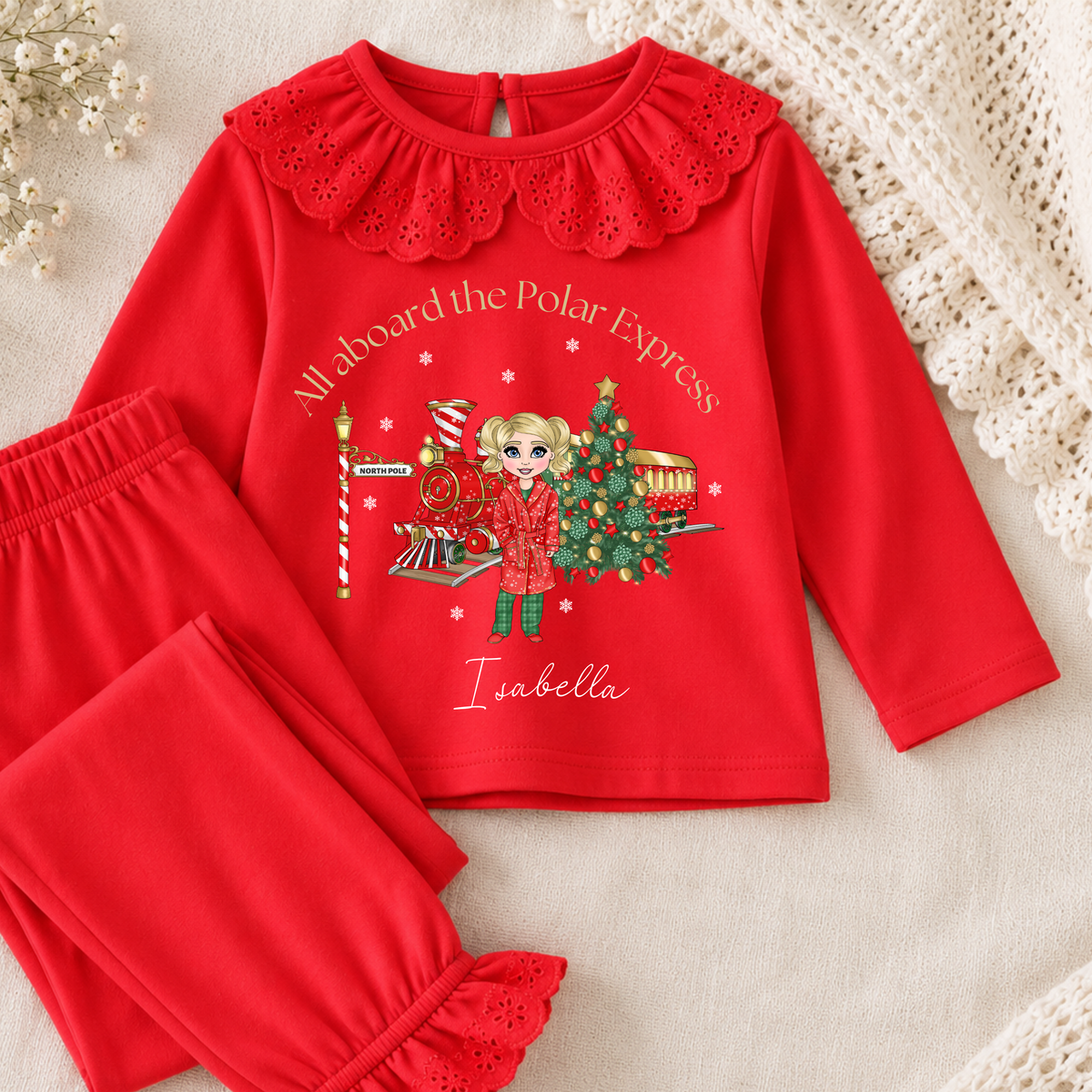 Personalised Christmas Pyjamas for girls with frill detail, custom name, Christmas doll, festive train and Christmas tree design.