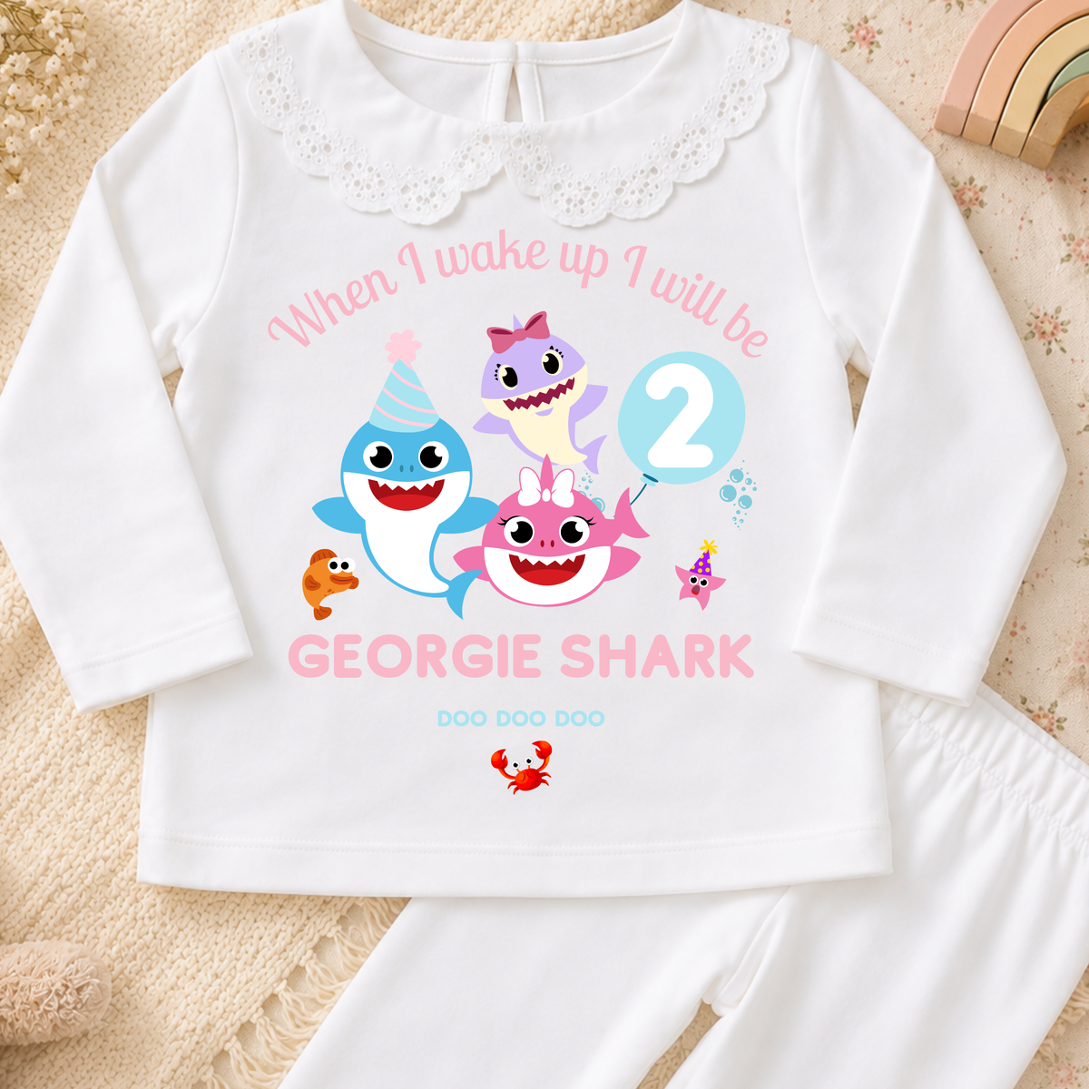 Personalised Baby Shark Birthday Pyjamas for Girls, white long sleeve PJs with pink and blue shark design, birthday age and custom name
