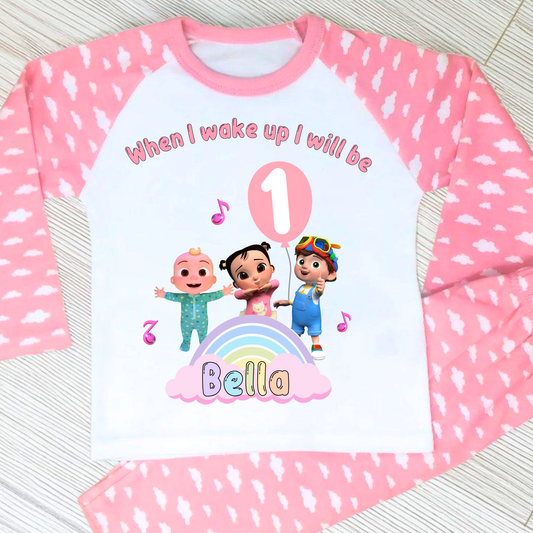Cocomelon Birthday Pyjamas: Image of a set of Cocomelon Birthday Pyjamas for children, displayed on a soft, pastel-hued background. The pyjamas are made from a soft fabric and showcase a pastel rainbow color scheme, adorned with popular Cocomelon characters. The ensemble is designed to be both stylish and comfortable, making it perfect for birthday celebrations or a cosy night. The image emphasizes the playful and whimsical nature of the pyjamas, capturing the essence of fun for young fans of Cocomelon.