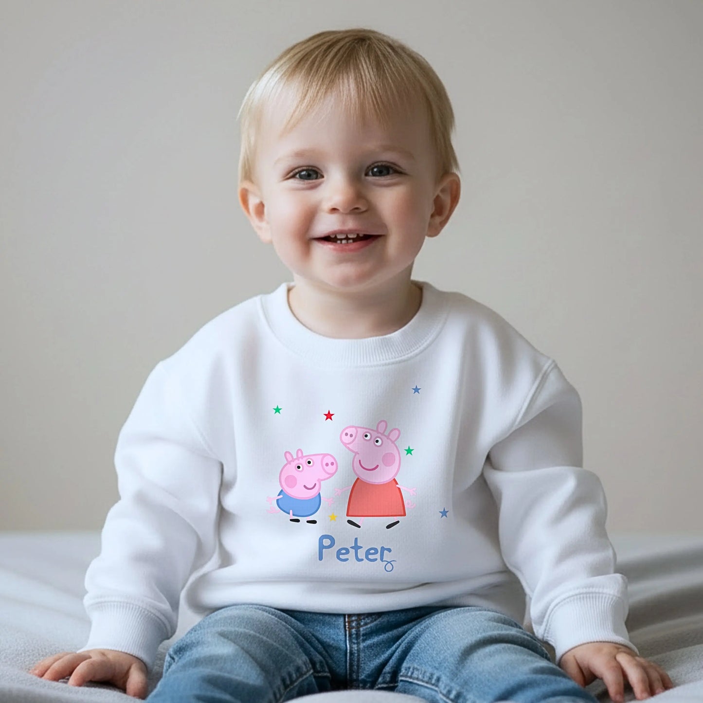 Personalised Peppa and George Sweatshirt: Child wearing a personalised Peppa and George Pig white sweatshirt with her custom name printed on it.