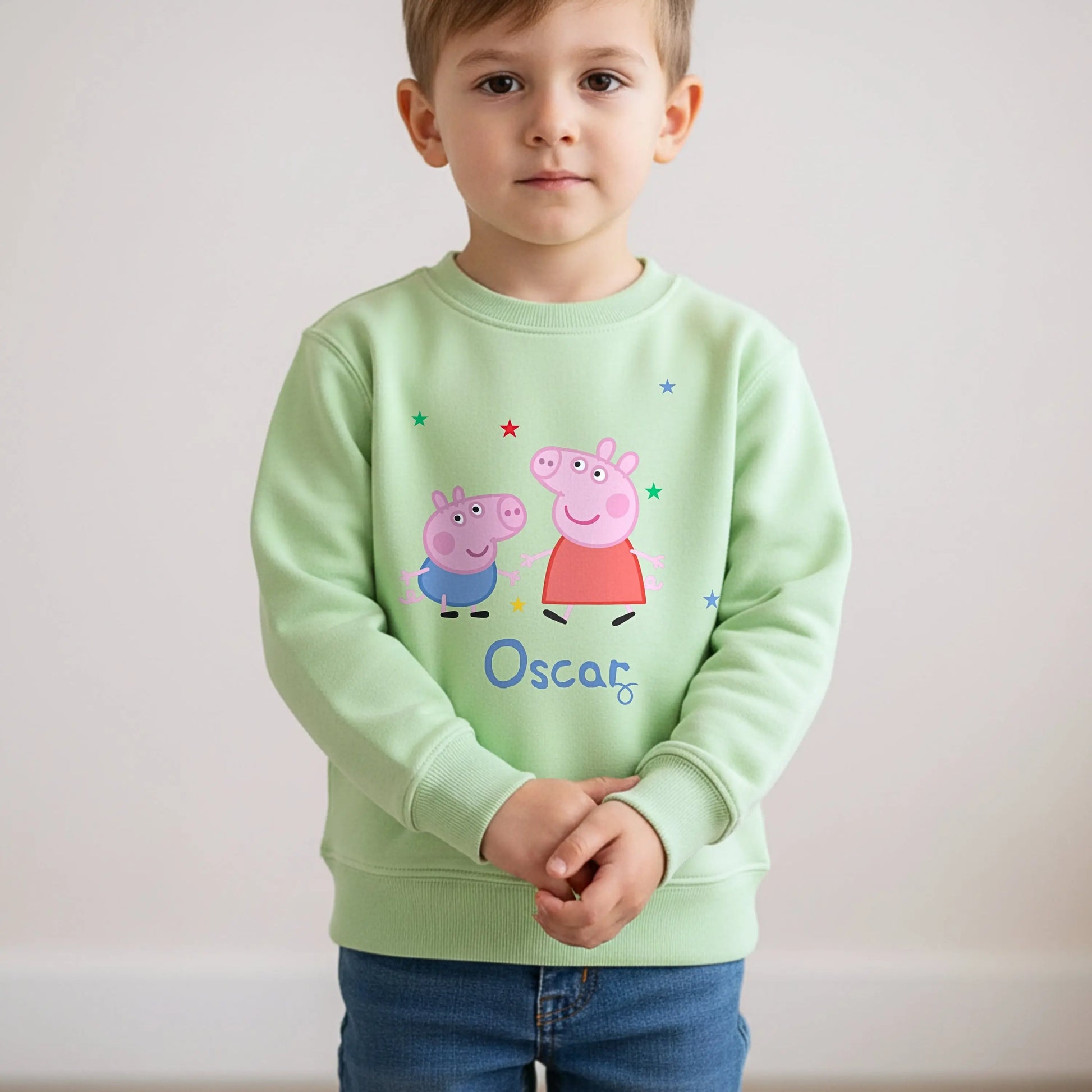 Personalised Peppa and George Sweatshirt: Child wearing a personalised Peppa and George Pig white sweatshirt with her custom name printed on it.