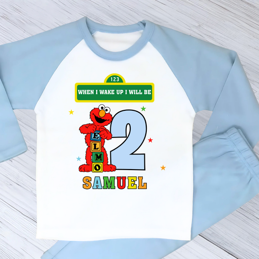 Elmo birthday pyjamas for boys with custom name and age, featuring Elmo from Sesame Street with bright birthday number, name printed underneath, soft and comfy pyjama set perfect for birthday morning celebrations