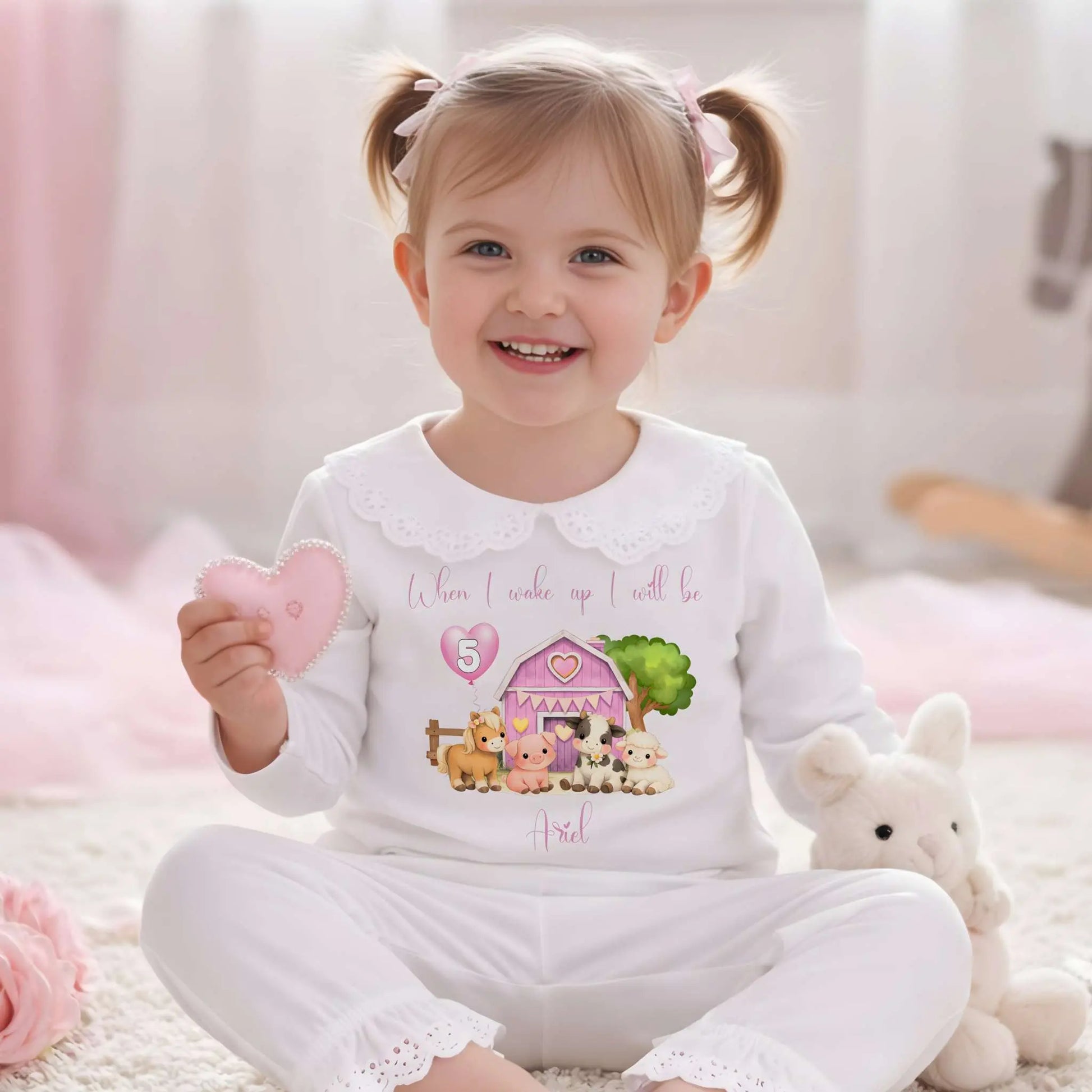 Farm Animal Birthday Pyjamas: Child wearing a white outfit with a Farm Animal Birthday Pyjamas for girls with personalised name, age balloon, cute farm animals, frilly collar and leg cuffs