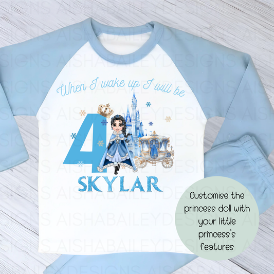 Princess birthday pyjamas: A set of personalised girls princess birthday pyjamas, titled "When I Wake Up Blue Snow Princess Custom Dolly Set." The pyjamas, made from 100% cotton for comfort, feature a customisable princess dolly with unique features and can be personalised with a child's name. Perfect for making a birthday girl feel like royalty with their enchanting design, ideal for birthday parties, sleepovers, or lounging at home.