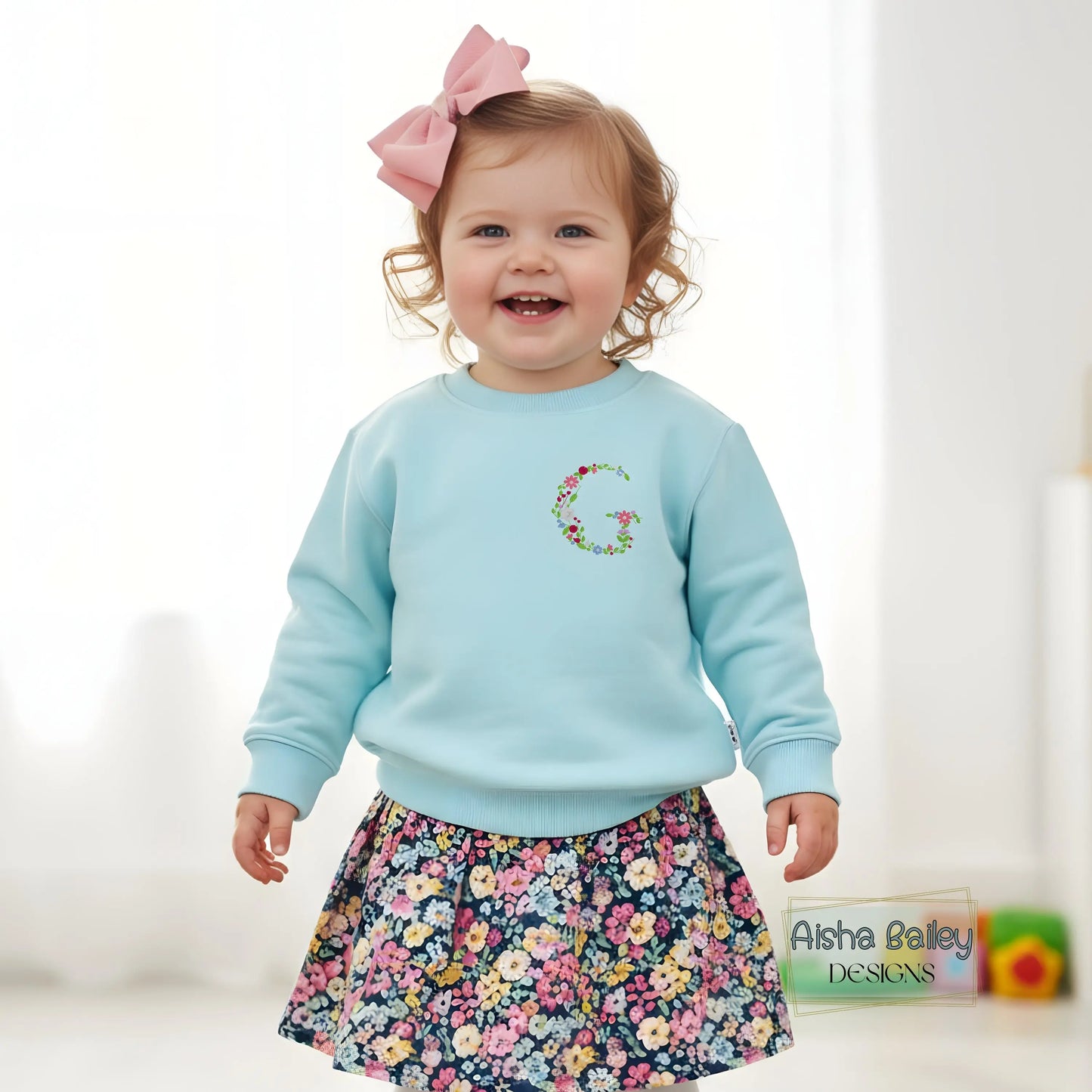 Floral initial embroidered sweatshirt: Floral initial girls sweatshirt featuring delicate embroidered flower letter design on soft kids jumper.