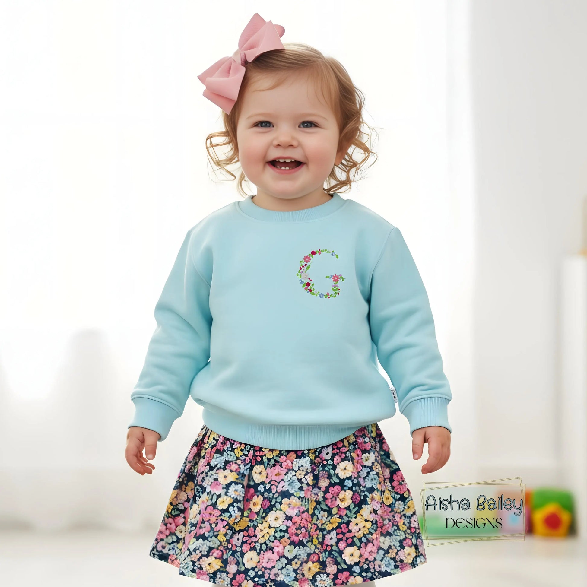 Floral initial embroidered sweatshirt: Floral initial girls sweatshirt featuring delicate embroidered flower letter design on soft kids jumper.