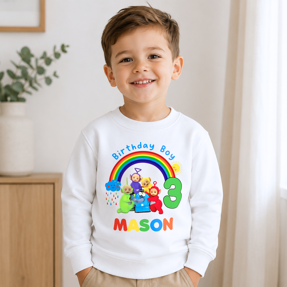 Personalised Boys Teletubbies Birthday Sweatshirt with rainbow design, custom name and age, available in white, blue and green.