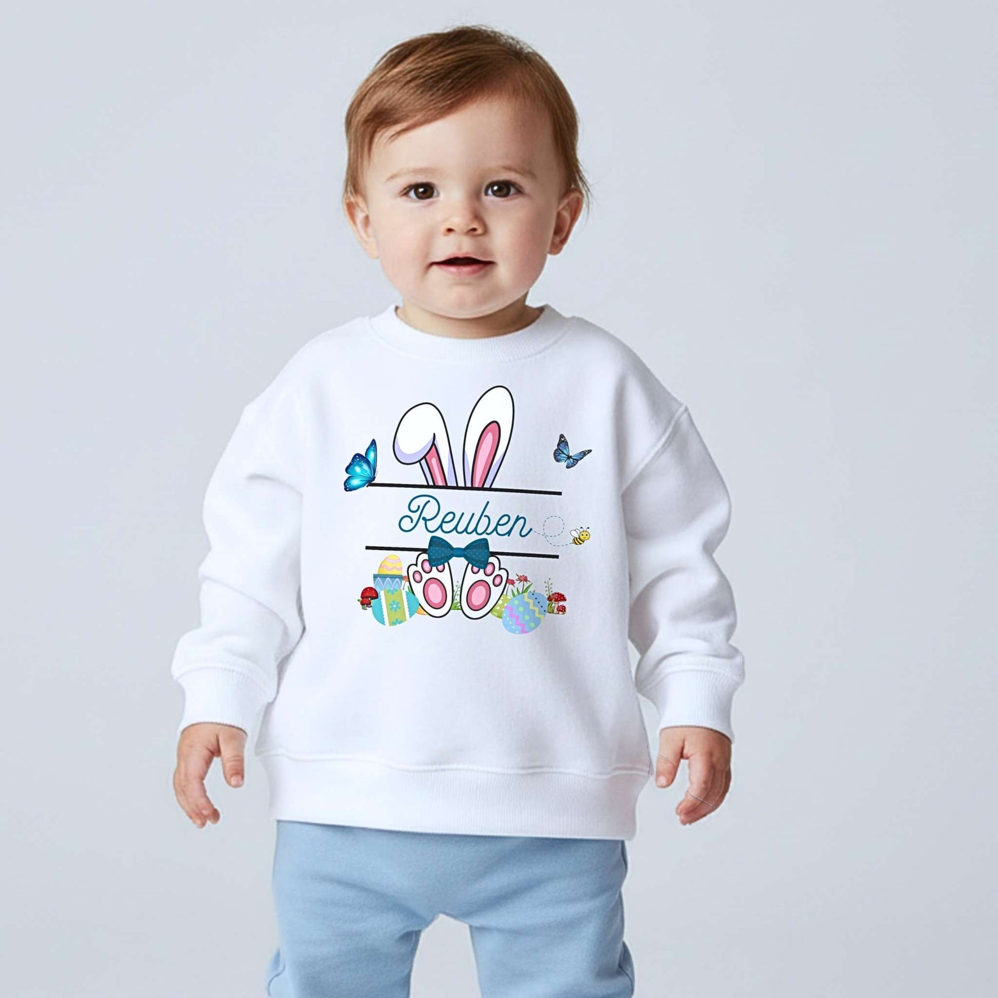Boys Easter top with personalised split monogram bunny design, available as t-shirt or sweatshirt. Custom name Easter top