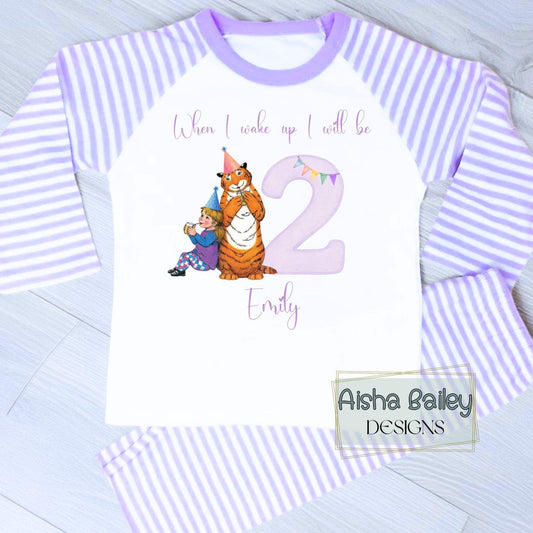 Personalised girls The Tiger Who Came For Tea birthday pyjamas with child’s name and age, featuring storybook tiger illustration and purple number design on soft cotton set.