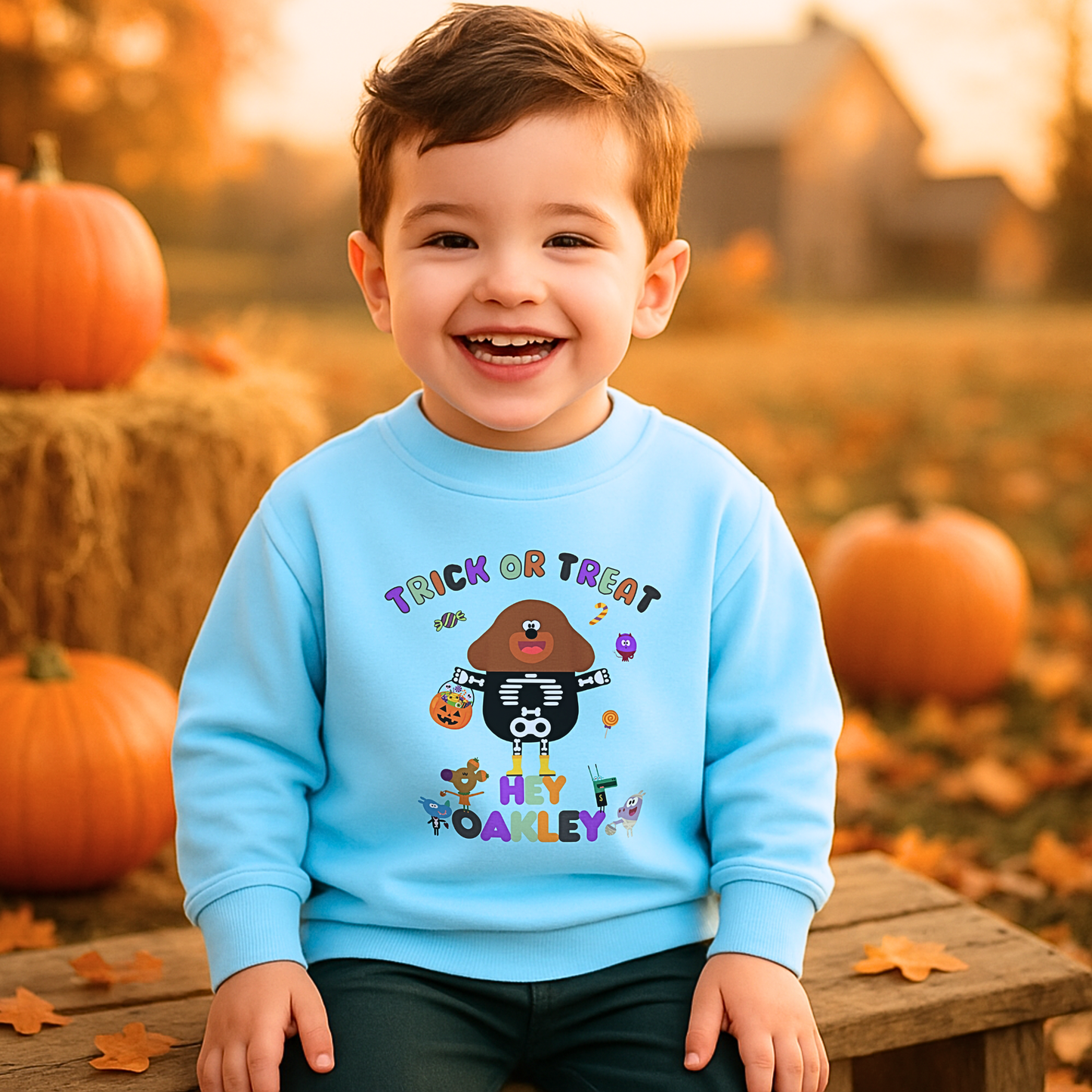 Child wearing personalised Halloween sweatshirt with trick-or-treat hey Duggee design and custom name