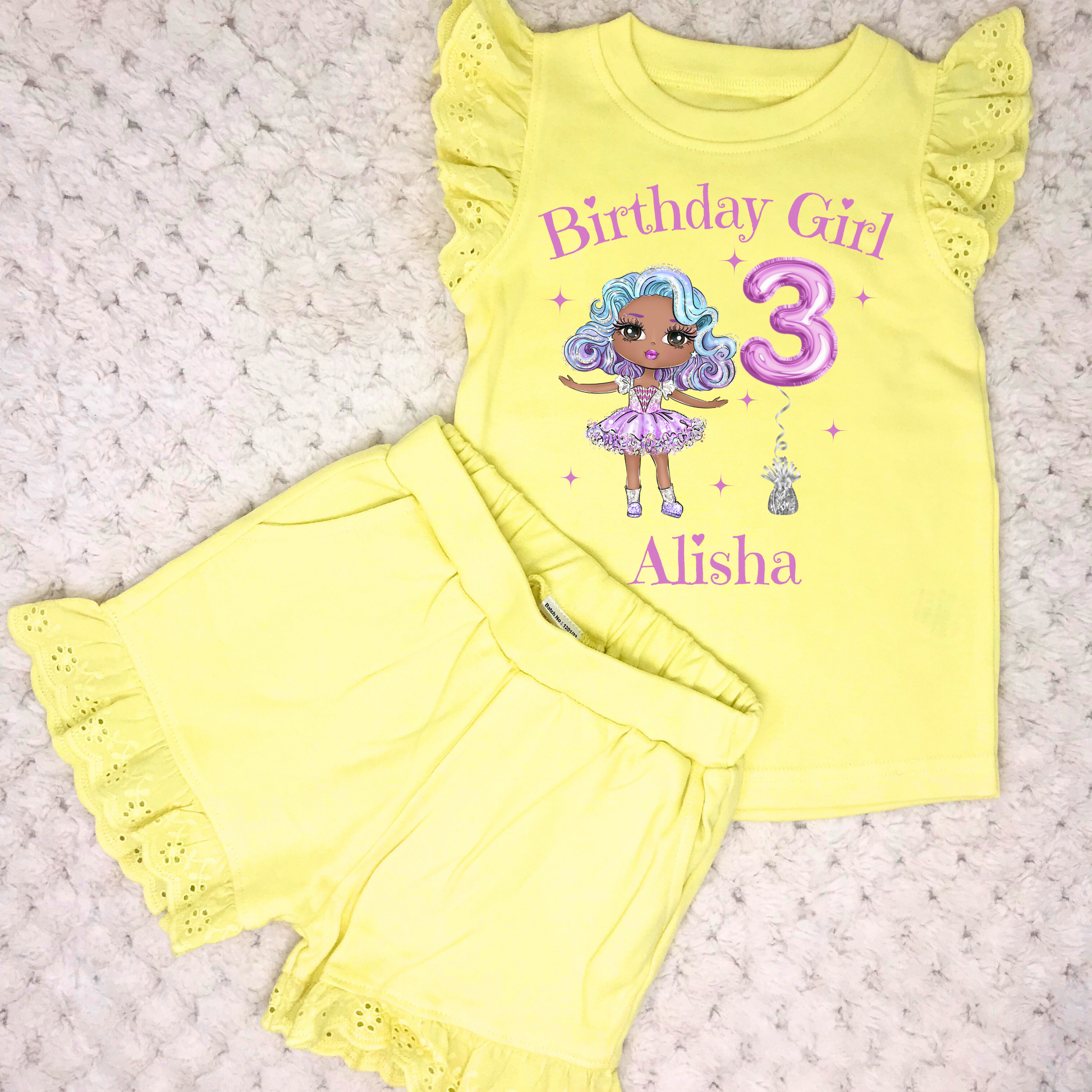 A vibrant and colourful personalised birthday outfit for girls, featuring a glitter-like design reminiscent of a pop star's ensemble. The set includes frilly shorts and a matching top, both adorned with rainbow hues, offering a playful and festive look. This personalised birthday girl outfit is perfect for a birthday celebration, capturing the spirit of fun and fashion. It also comes with a custom rainbow doll in the design, making it an ideal gift for young fashion enthusiasts.