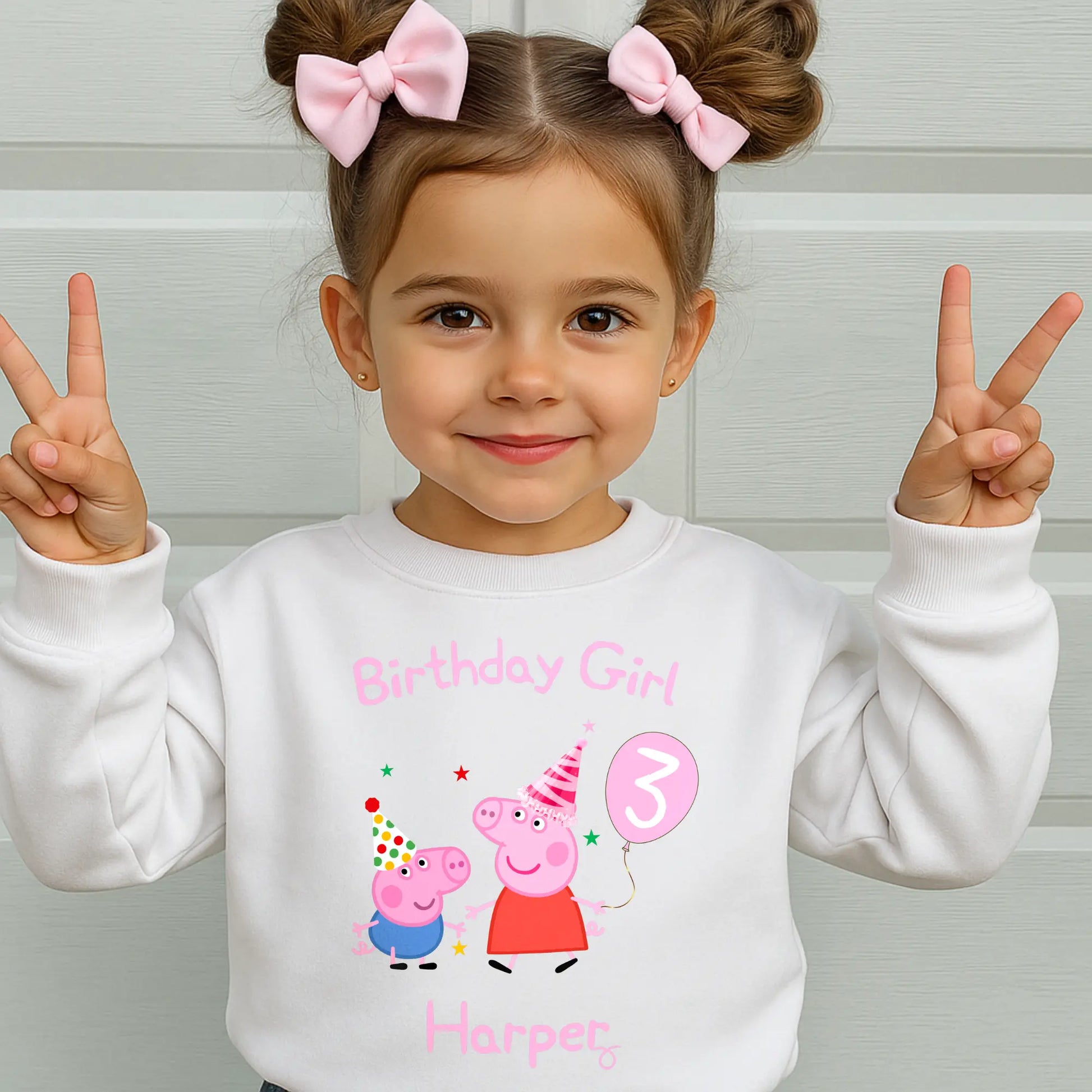 Peppa and George pig birthday sweatshirt: Child wearing a personalised Peppa and George white sweatshirt with 'Birthday Girl' and her custom age and name, standing against a light background.