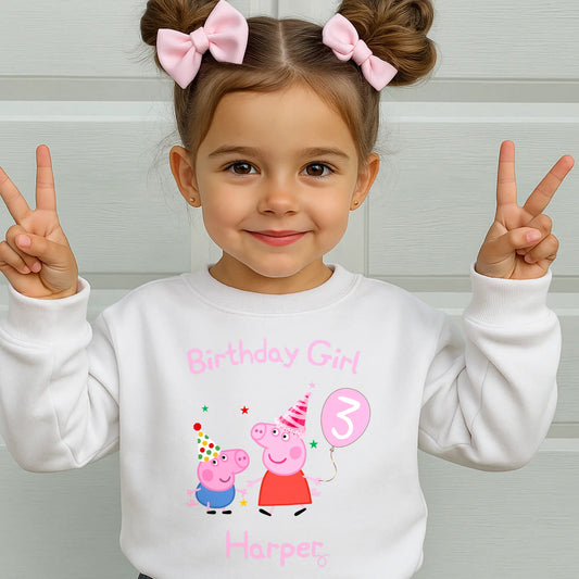 Peppa and George pig birthday sweatshirt: Child wearing a personalised Peppa and George white sweatshirt with 'Birthday Girl' and her custom age and name, standing against a light background.