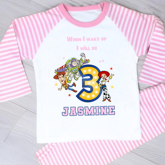 Toy Story birthday pyjamas for girls with custom name and age, featuring Buzz Lightyear, Woody, and Jessie, bold birthday number in Toy Story colours, and name printed underneath, soft and comfy sleepwear set for birthday mornings