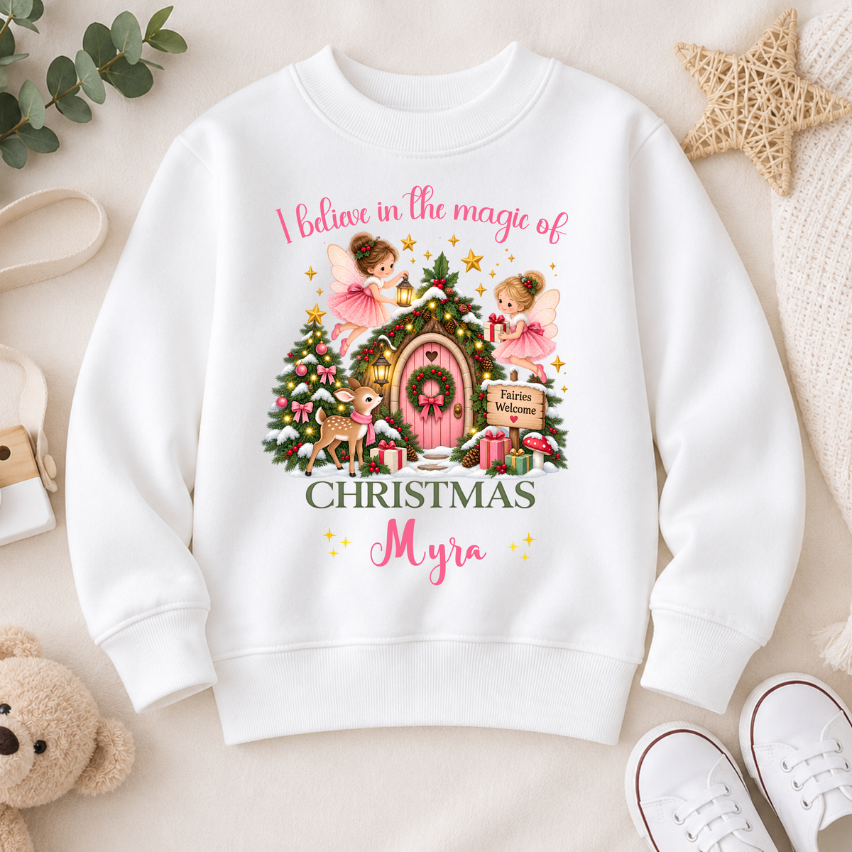 Personalised Christmas Sweatshirt for girls with magical fairies, pink fairy door, Christmas tree, woodland deer and child’s custom name.
