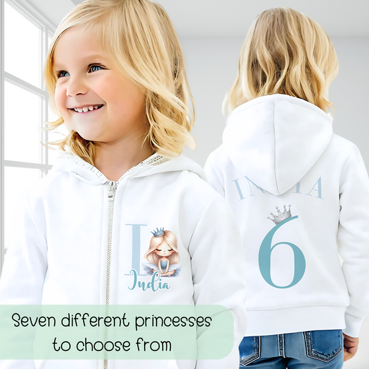 A personalised girls princess hoodie with a zipper, inspired by an ice princess theme. The hoodie is in an ice blue colour palette and features an initial, name, and princess design on the front left. The back displays the child's name and chosen number along with a silver crown, perfect for toddlers and young girls who adore princesses. Princess Gift, princess hoodie, name number hoodie