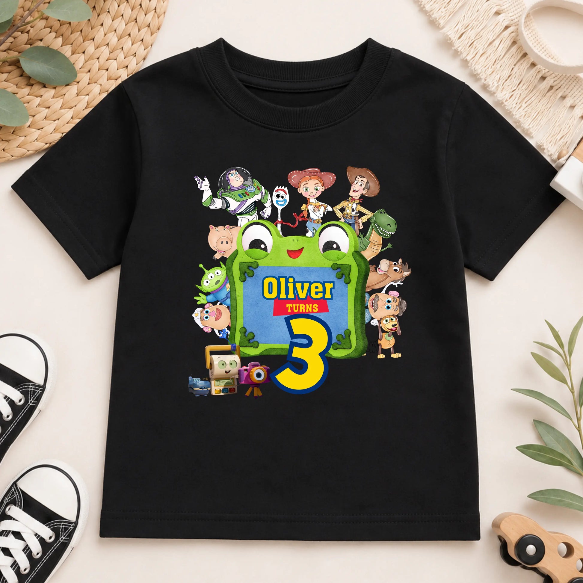 Personalised Toy Story birthday T-shirt for boys featuring custom name and age with colourful Toy Story-inspired characters including Buzz, Woody and friends, perfect for a birthday party outfit, cake smash and birthday photos.