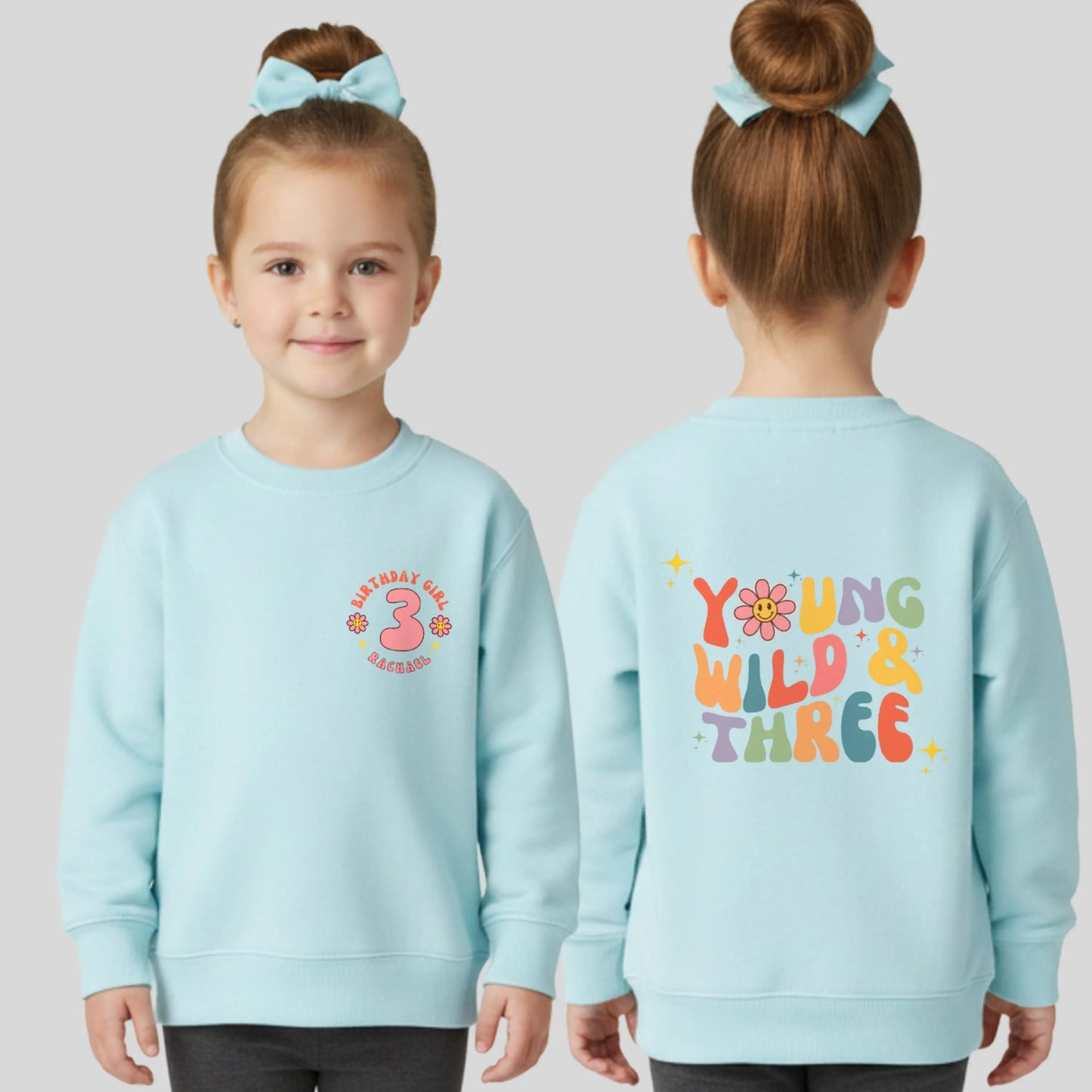 Girls Young Wild and Three birthday sweatshirt in groovy retro style, featuring birthday girl text, retro emojis, a personalised name on the front and bold nostalgic graphics on the back