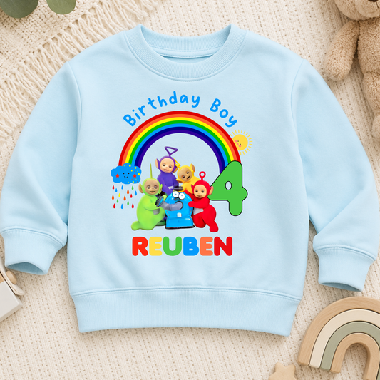 Personalised Boys Teletubbies Birthday Sweatshirt with rainbow design, custom name and age, available in white, blue and green.