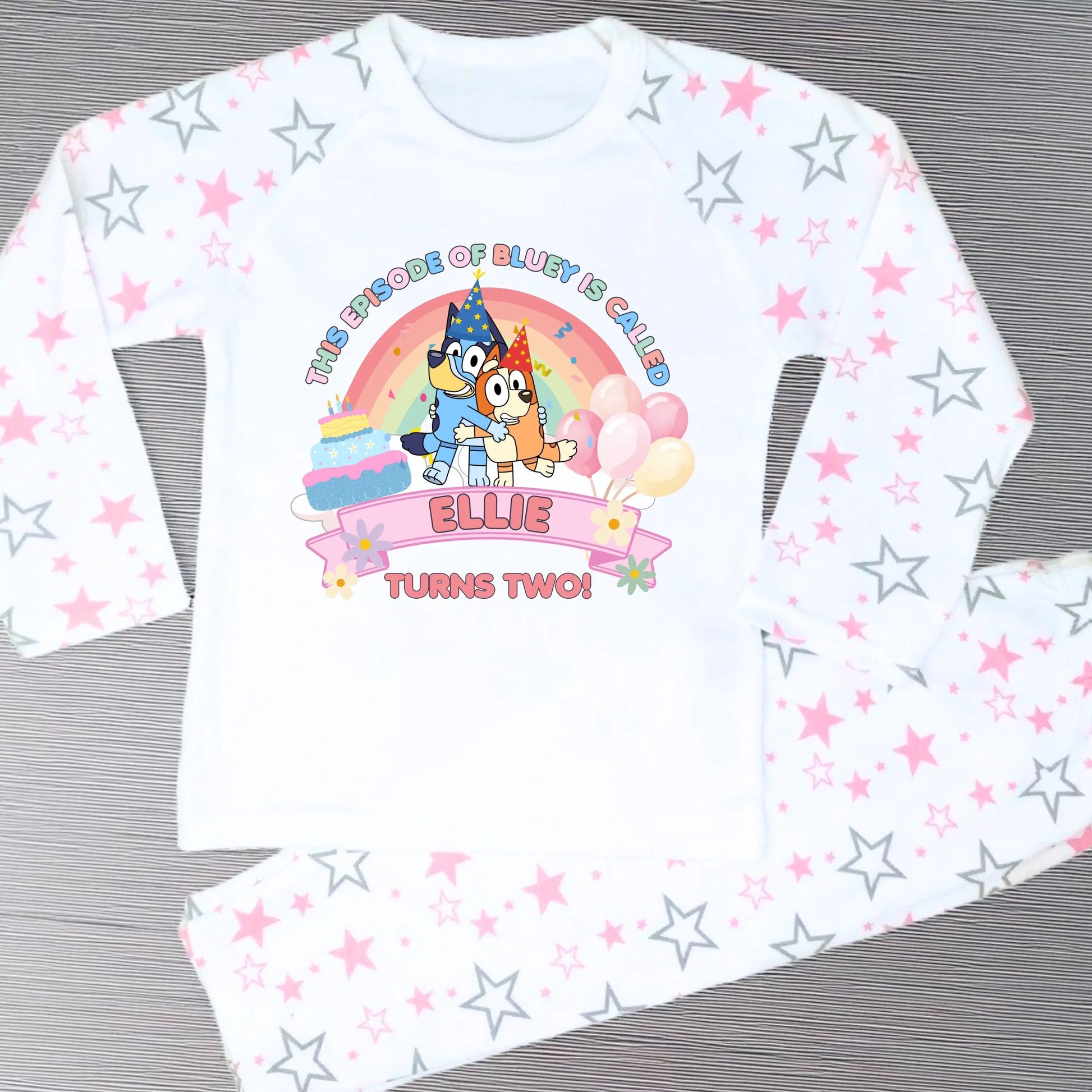 Pink Bluey and Bingo Birthday Pyjamas for Girls with rainbow design and customisable text.