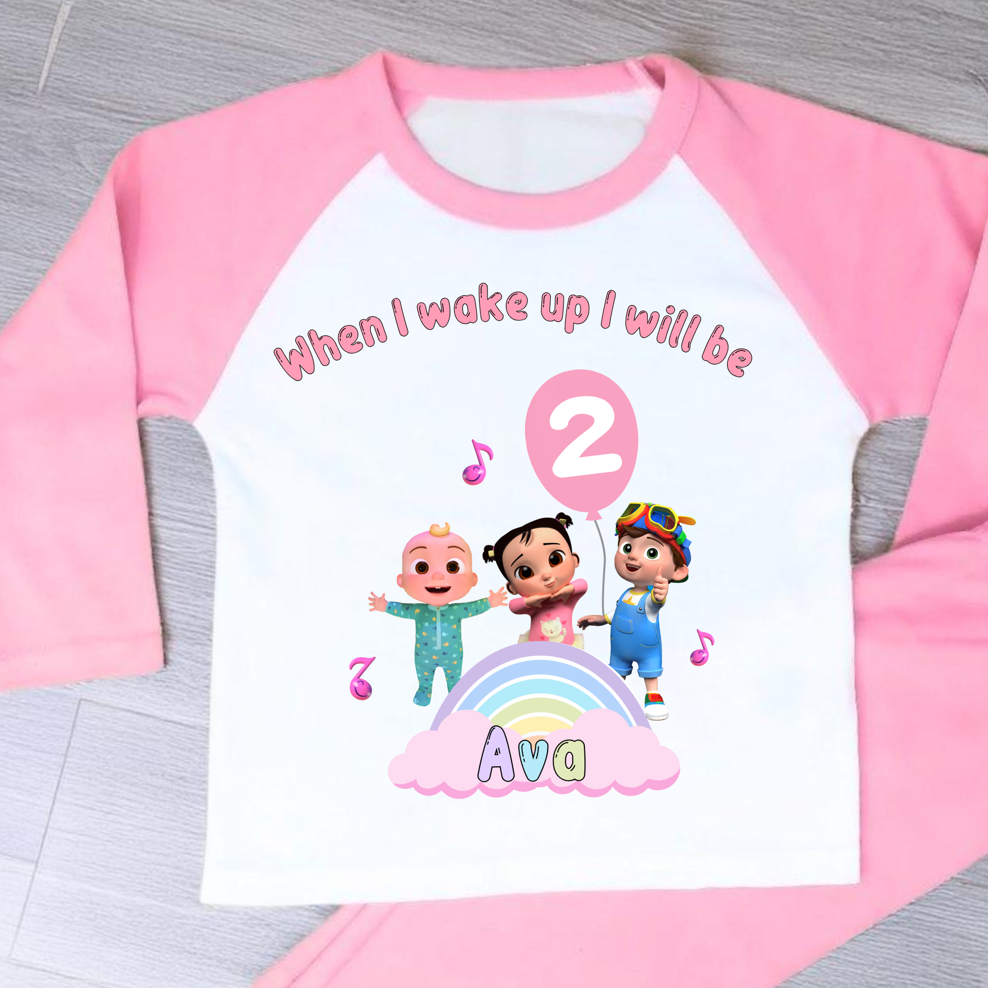 Cocomelon Birthday Pyjamas: Image of a set of Cocomelon Birthday Pyjamas for children, displayed on a soft, pastel-hued background. The pyjamas are made from a soft fabric and showcase a pastel rainbow color scheme, adorned with popular Cocomelon characters. The ensemble is designed to be both stylish and comfortable, making it perfect for birthday celebrations or a cosy night. The image emphasizes the playful and whimsical nature of the pyjamas, capturing the essence of fun for young fans of Cocomelon.