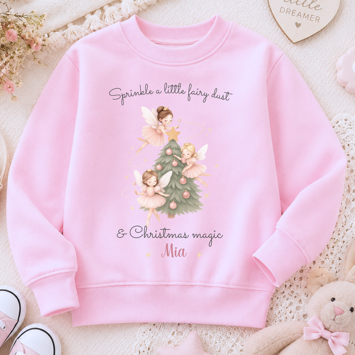 Girls Christmas Sweatshirt with personalised name, featuring three pink fairies decorating a festive Christmas tree with soft pink baubles.