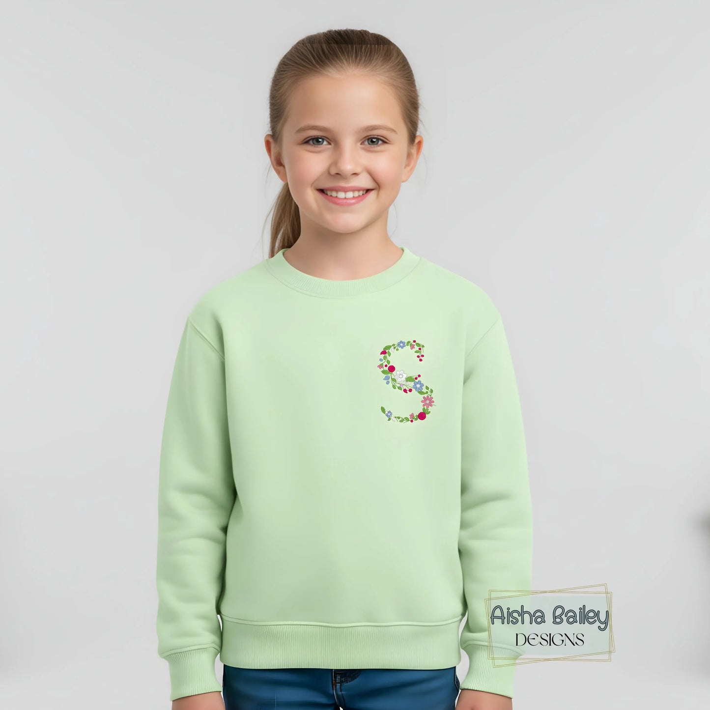 Floral initial embroidered sweatshirt: Floral initial girls sweatshirt featuring delicate embroidered flower letter design on soft kids jumper.