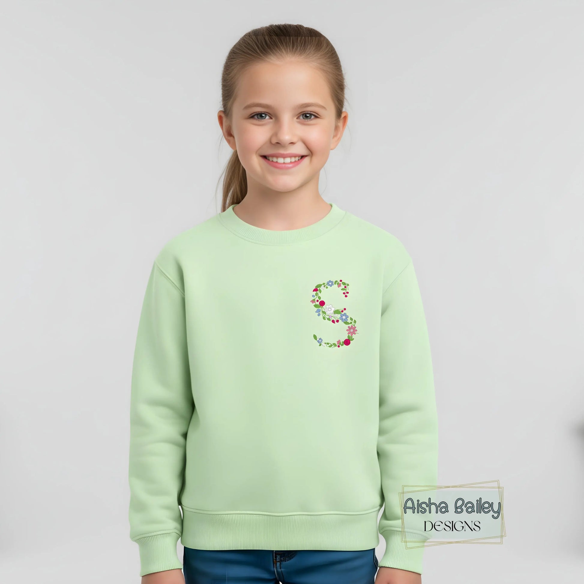Floral initial embroidered sweatshirt: Floral initial girls sweatshirt featuring delicate embroidered flower letter design on soft kids jumper.
